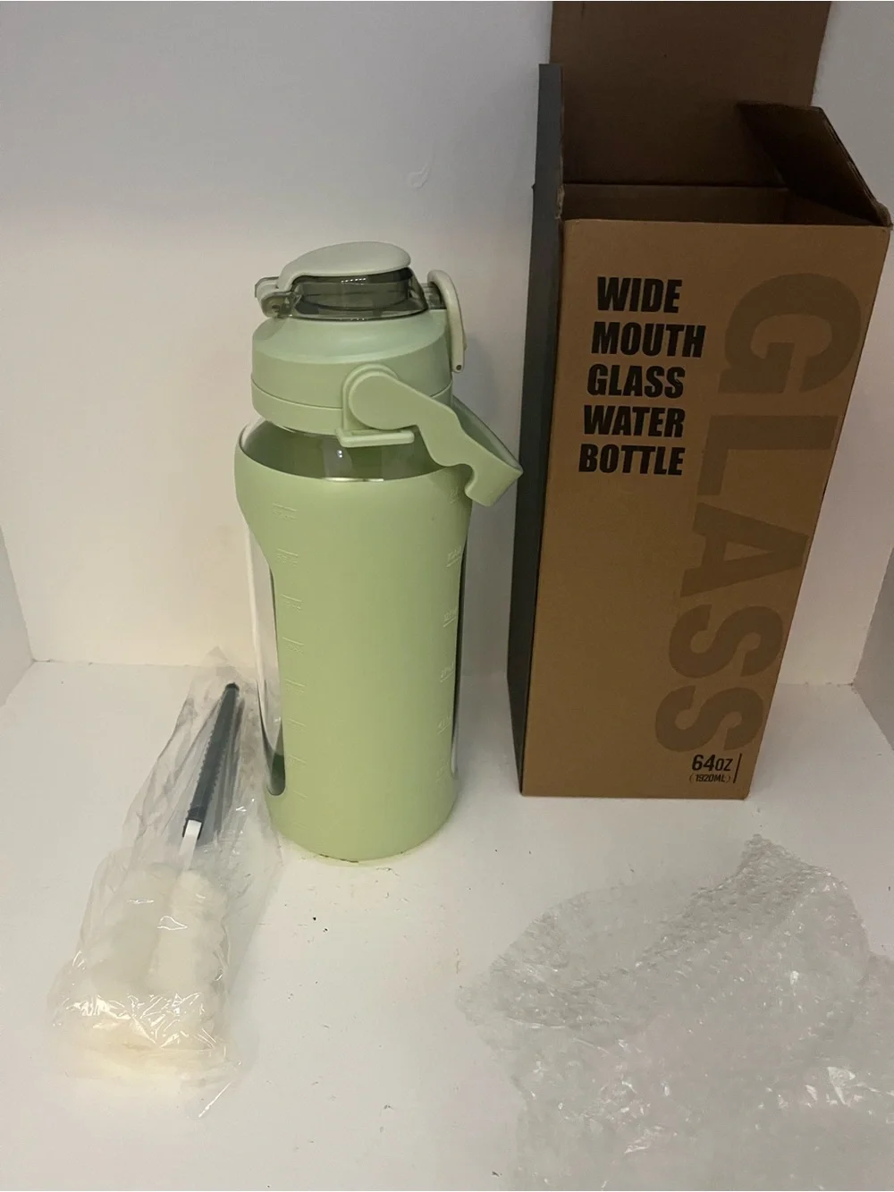 64 fl oz Wide Mouth Glass Water Bottle Green Silicone Sleeve, Flip-Top, Straw